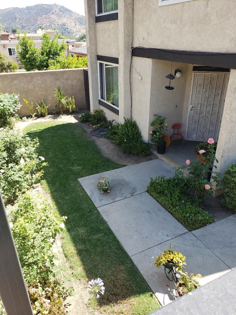 a yard with grass and a house with a door